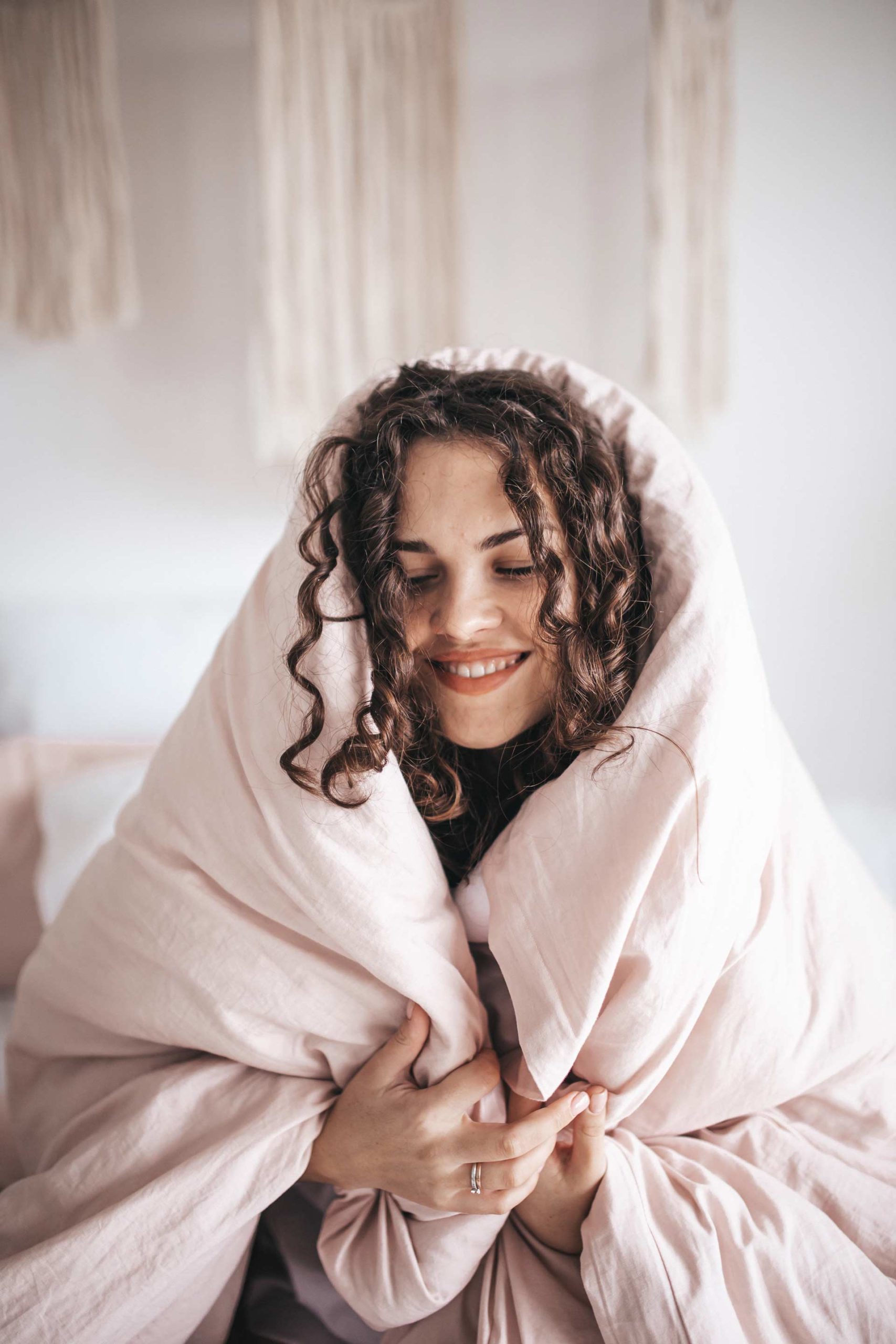 woman wrapped in blanket smiling